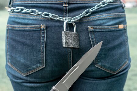 The female is locked in its middle part in the chain and lock of the castle. The army knife is aimed...