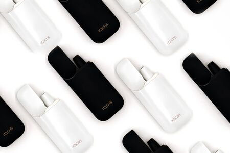 White Iqos device battery and black Iqos device battery isolated on white background. Lots of Iqos. Russia, Tatarstan, September 08, 2019のeditorial素材