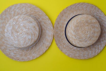 Modern stylish boater straw hats on a yellow background.Trip, travel and tourism concept. Space for textの写真素材