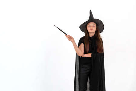 A girl dressed as Harry Potter with a magic wand in her hands