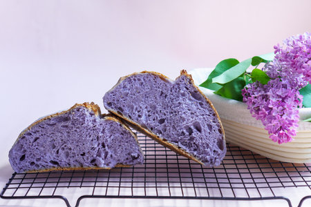 Homemade Artisan Purple Bread Sourdough Made from Purple Sweet Potato. with natural color. Purple tartine cut into slices.の写真素材