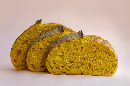 Freshly baked homemade Unusual and creative yellow artisan sourdough bread. Sliced. Copy space.の写真素材