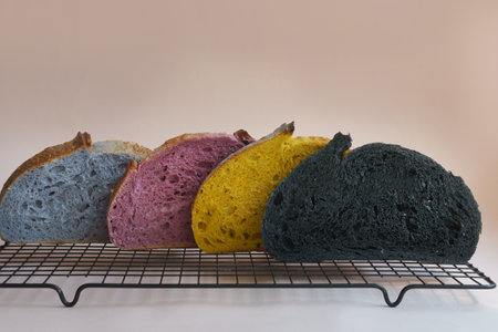 Freshly baked homemade Unusual and creative colorful artisan sourdough bread. Sliced. Copy space.