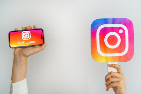 Girl holding a phone with a Instagram logo and the inscription Instagram. Turkey, Istanbul, September 17, 2024.のeditorial素材