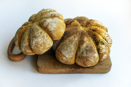 Unusual homemade handmade breads in the shape of a pumpkin on a white background. Space for text.の写真素材