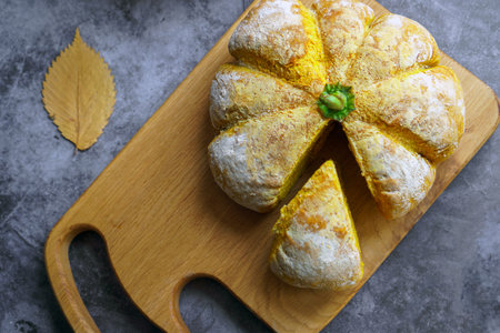 Top view Homemade sourdough bread in the shape of a pumpkin on a gray background. Autumn pumpkin bun.の写真素材