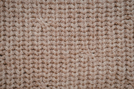 A close-up view of a brown knitted fabric showing its texture and weave pattern.