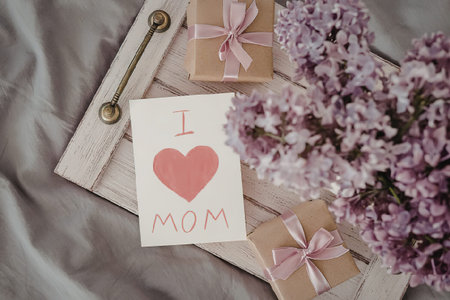 A beautiful arrangement of gifts and flowers with a heartfelt note for mom