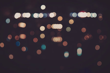 A blurry image of city lights at night, with colorful bokeh effectの写真素材