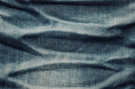 A close-up view of a denim fabric showcasing its texture and patternの写真素材