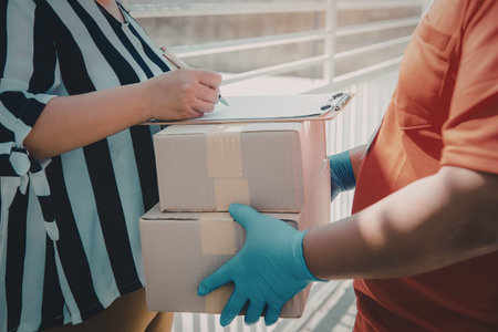 a person in a black and white striped shirt handing over two packages to another person wearing a...