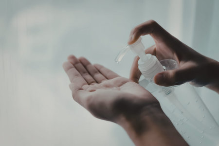 A person is applying hand sanitizer to their palm.