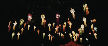 A mesmerizing display of colorful lanterns lit up against a dark background, creating a stunning...