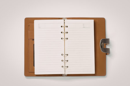 An open brown leather notebook with blank white pages and a metal clasp.