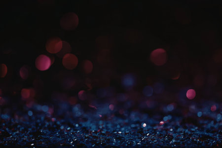 A mesmerizing image of glowing blue and pink sparkles scattered across a dark background, creating a...