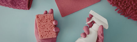 A collection of pink cleaning supplies, including a sponge and scrubber, on a blue background