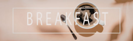 A breakfast setup with a cup of coffee or espresso and a spoon