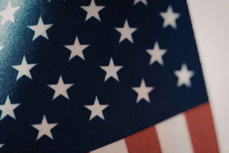 A close-up view of the American flag, showcasing its blue field with white stars and red and white...