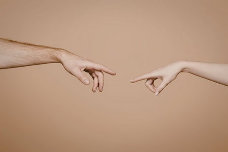 Two hands almost touching each other with index fingers extended