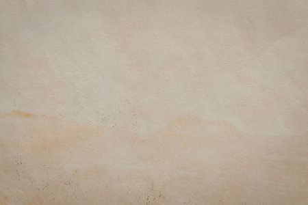 A beige background with a textured surface, possibly a wall or a piece of paper.