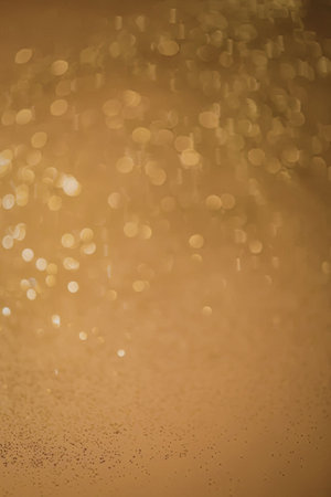 A mesmerizing display of golden bokeh lights shining brightly against a warm, dark background.