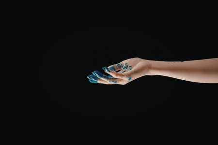 A hand with glowing blue nails on a black background