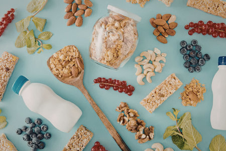 A variety of healthy snack options including granola bars, nuts, seeds, and milk