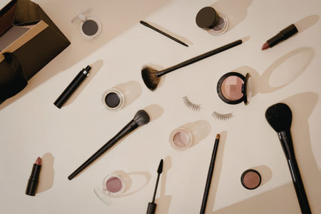 A collection of makeup brushes and cosmetics arranged on a table