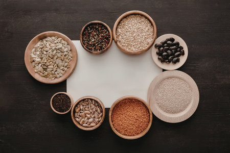 An arrangement of wooden bowls containing different types of grains and seedsの写真素材