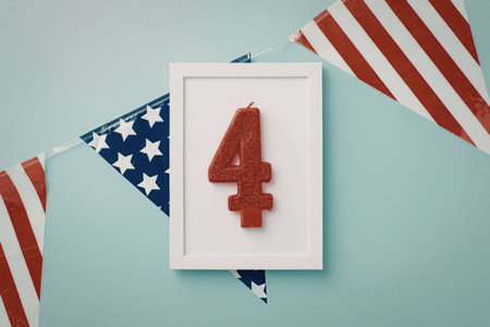 Red number 4 candle in a white frame surrounded by patriotic bunting on a blue background...