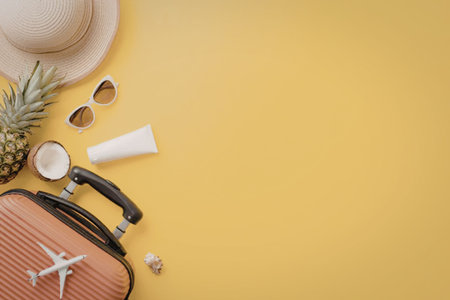 Various summer vacation packing essentials like a suitcase, straw hat, sunglasses, and pineapple are...