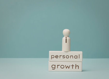 Simple image showing wooden blocks with words personal growth against blue backdrop.