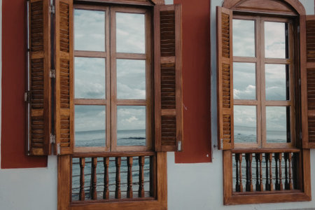 Detail of wooden window shutters on a building with a city view in the background