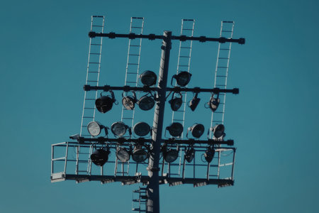Workers on tall electrical power line tower repairing or maintaining lines outdoors
