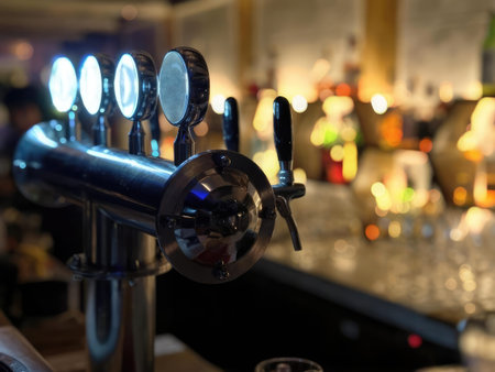 Close-up of beer tap handles and bottles in a cozy bar setting with warm light.