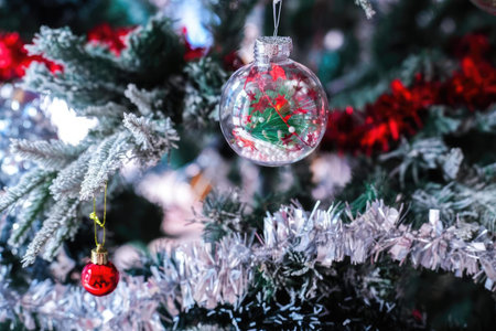 Close-up of decorated Christmas tree with colorful ornaments and lights.
