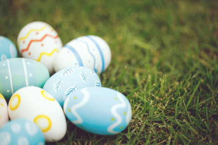Vivid decorated Easter eggs resting on green grass for spring and holiday themes