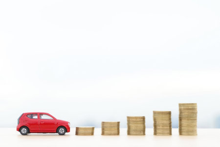 Cute red toy car with increasing stacks of coins, showing growth and savings concept.