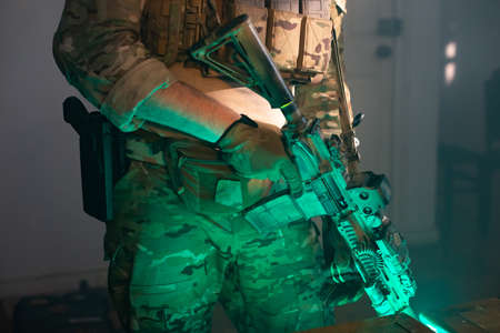 Cropped image of man in military equipment. Man in uniform holding machine gun. Military, army,...