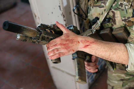 Close-up of man in military equipment with gun. Man in uniform holding machine gun. Military, army, weapon airsoft conceptの写真素材