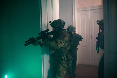 Interested men playing strikeball together. Men in military uniforms aiming, looking for enemies....