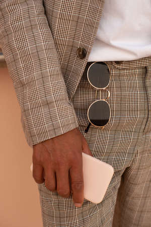 Cropped image of African American man holding phone. Male hand holding modern device. Technology conceptの写真素材