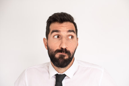 Humorous bearded man making funny face. Male model in suit fooling around. Portrait, emotion conceptの写真素材