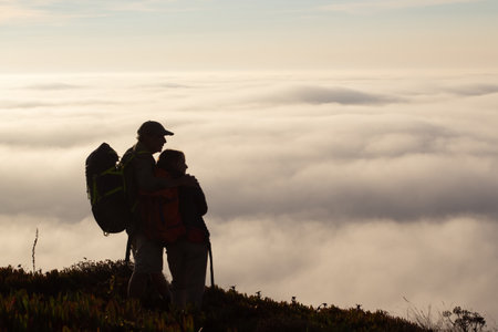 Loving family hiking on summer. Man and woman in casual clothes and with ammunition hugging. Hobby, active lifestyle conceptの写真素材