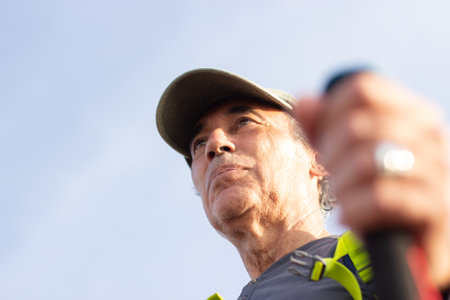 Bottom view of elderly hiker. Man in cap with greying hair. Hobby, nature, outdoor activity conceptの写真素材