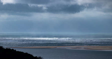 View of the Atlantic ocean with stormclouds and swirl patterns under a dramatic sky, Dune du Pilat, Franceの写真素材