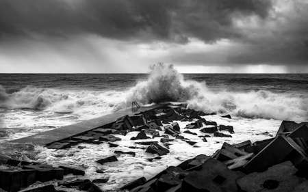 Seascape view of freak wave hitting the shore in a thunderstormの写真素材