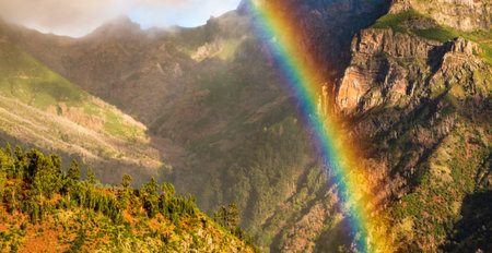 Mountain view of rainbow over rocky canyon, Madeira, Portugalの写真素材