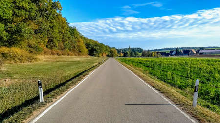 Driver POV along empty country road on a bright summer dayの写真素材