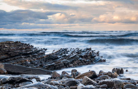 seascape view of waves breaking on the famous rocky coastline Flysch cliffs in winter, Basque...